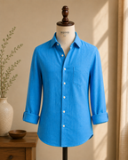 ROYYD Rama green linen shirt displayed on a hanger, featuring a relaxed fit with a classic collar and long sleeves.